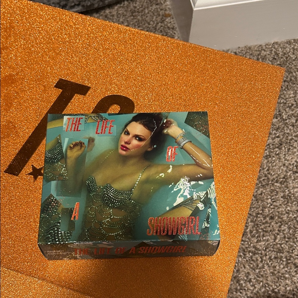 The Life of a Showgirl Keychain, photo, and a cd